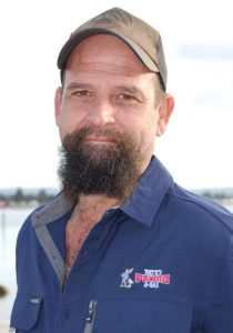 Phil Kerin from Trent's Plumbing & Gas - bearded man wearing cap and navy blue shirt with the logo and name of Trent's Plumbing and Gas.