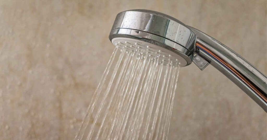 Water saving showerhead spraying water.